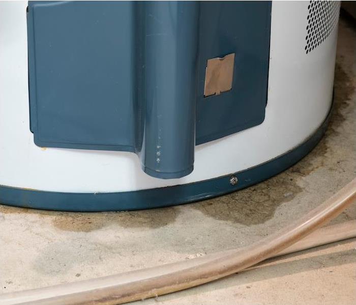 a blue and white hot water heater showing signs of a water leak